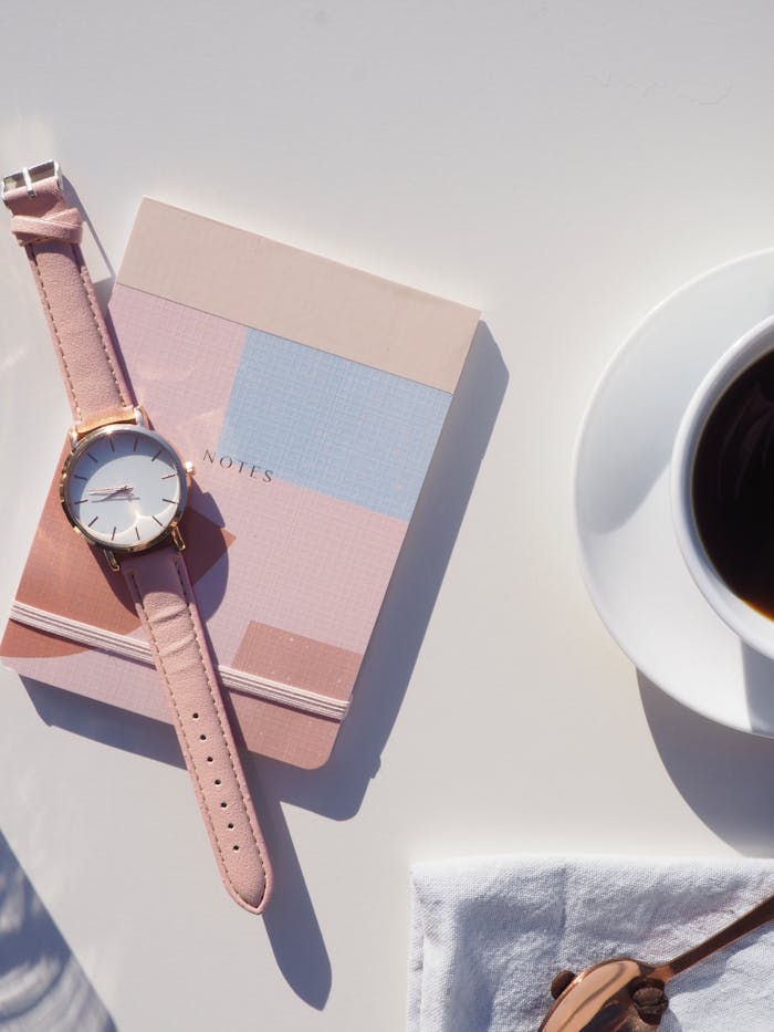 pexels-photo-1162519-1 Round Gold-colored Analog Watch With Pink Leather Strap on Pink Notebook